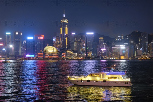 Hong Kong skyline cityscape downtown skyscrapers over Victoria Harbour in the evening illuminated