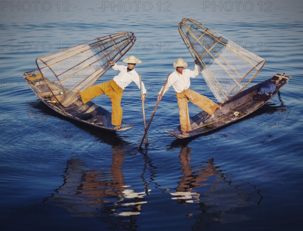 Myanmar travel attraction, Traditional Burmese fishermen balancing with fishing nets at Inle lake