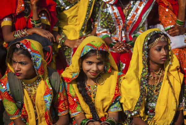 PUSHKAR, INDIA, NOVEMBER 21, 2012: Unidentified Rajasthani girls in traditional outfits prepare for