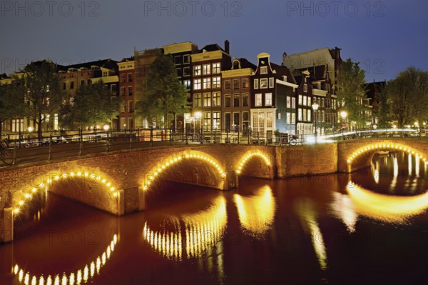 Seven bridges illuminated with neon lights at the corner of Keizersgracht and Reguliersgracht,