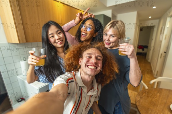 Group of cheerful multi ethnic friends taking a selfie while enjoying glasses of juice together in