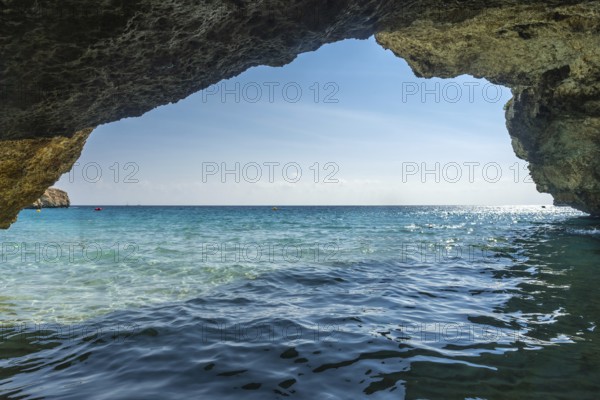 Crystal clear turquoise waters of the mediterranean sea glisten under the summer sun, viewed from
