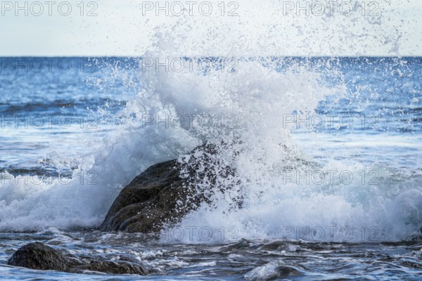 Rocks and sea on the beach of Playa del Inglés. Splashing spray from a wave. Valle Gran Rey, La