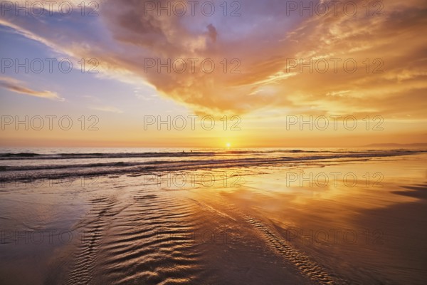 Atlantic ocean sunset with surging waves at Fonte da Telha beach, Costa da Caparica, Portugal,