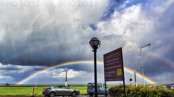 View of the coast road from the Strand Hotel, double rainbow in the cloudy sky, Bray, Wicklow,