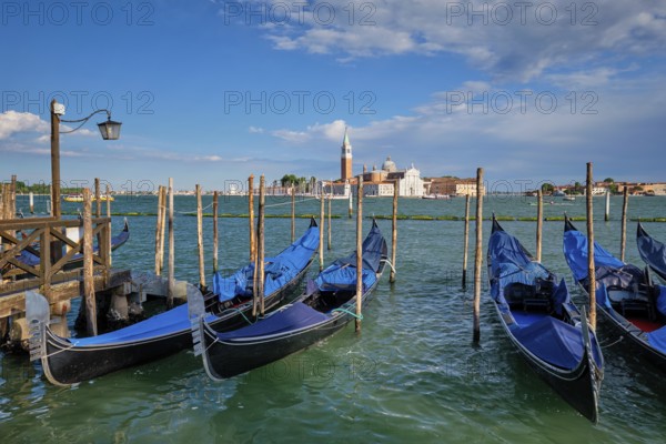 Gondolas and in lagoon of Venice by Saint Mark (San Marco) square with San Giorgio di Maggiore