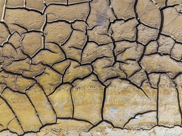 Mineral-rich cracked earth at the bank of the Rio Tinto (Red river), aerial view, drone shot,