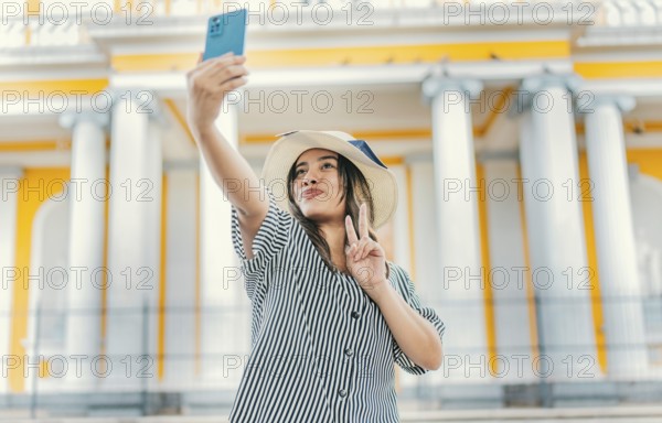 Beautiful tourist girl taking selfie in the cathedral of Granada. Young tourist woman with hat