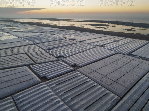 Masses of shimmering plastic greenhouses at the coast of El Ejido aside with the lagoon Salinas de
