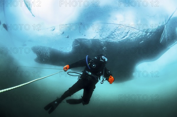 Scuba diver under the ice, Lake Baikal, Olkhon Island, Pribaikalsky National Park, Irkutsk