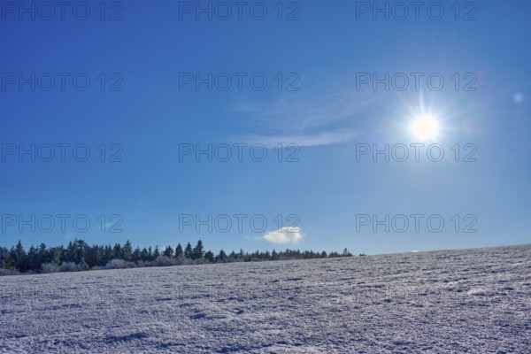 Wide expanse of snow under a clear blue sky with bright sun, winter, Wasserkuppe, Gersfeld, Rhön,