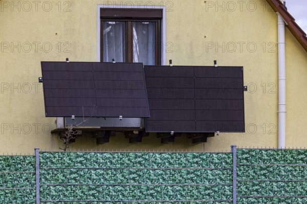 Plastic fence in leaf look on a detached house. Balcony power station. Stuttgart,