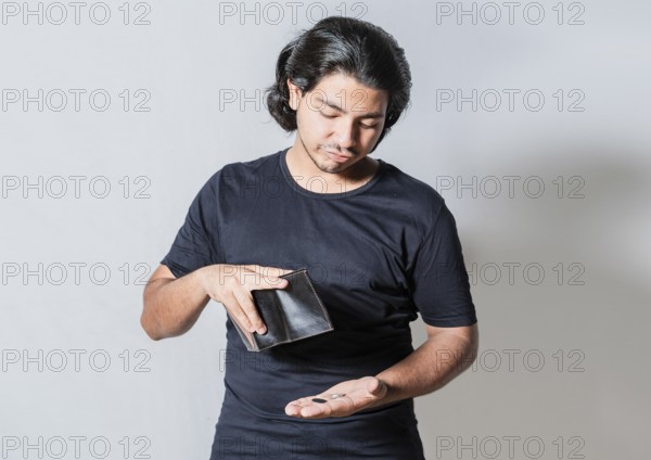 Unhappy man with financial crisis isolated. Person with financial crisis holding wallet. Sad man