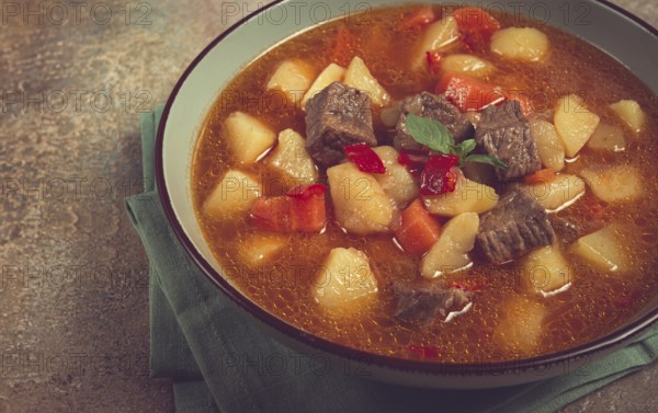Meat goulash, with potatoes and carrots, sweet pepper, traditional Hungarian soup, homemade, no
