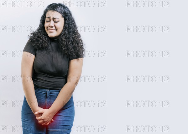 Young woman with urinary problems isolated. Girl with hands on crotch with urinary problems. People