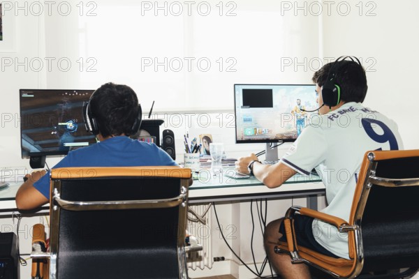 Madrid, Spain, August 23, 2019: Teenagers playing Fortnite video game and CSGO Counter Strike on PC