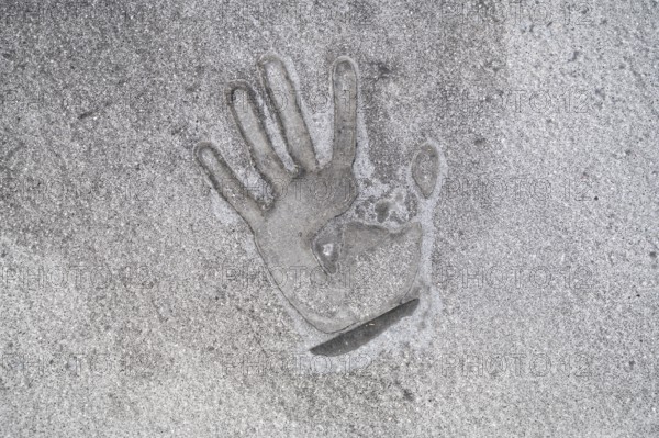 01/05/2023, Berlin, Germany, Europe, A handprint left on the tarmac with superglue a few days after
