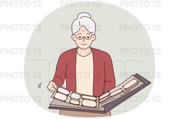 Elderly woman flips through family photo album, remembering student years or fun trips with friends