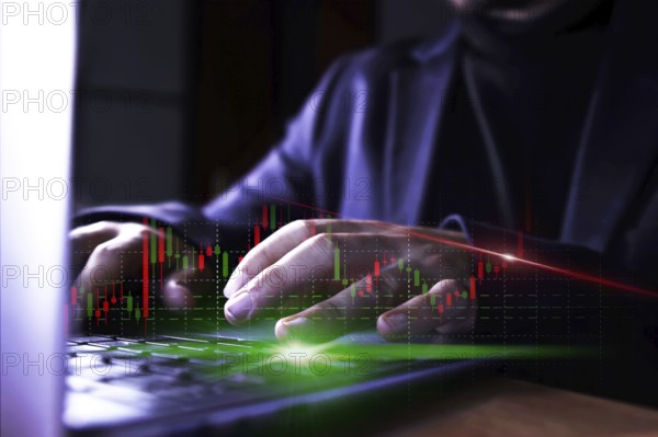 Businessman using computer with stock market virtual increasing stock market graph chart. Business