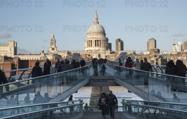 London, United Kingdom, December 8 2015: People walking at the Millennium bridge, officially known