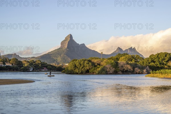 A bay on a river. Dream beach in a pastel-coloured sunset on a holiday island. A gently sloping