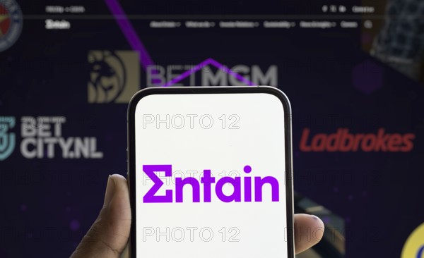 Dhaka, Bangladesh- 28 Nov 2024: Entain logo is displayed on smartphone.Entain plc is an