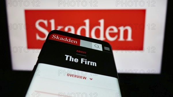 Stuttgart, Germany, 12-17-2023: Mobile phone with website of US law firm Skadden, Arps, Slate,