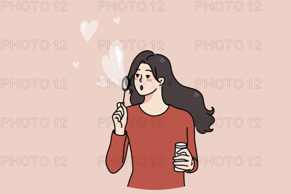 Happy young woman blow soap bubbles with heart shape. Kind girl share spread love and care. Concept