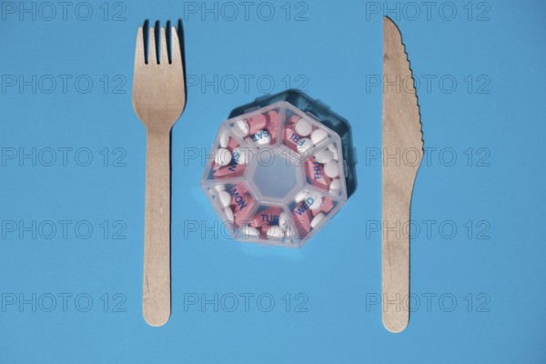 Organizer weekly shots with fork and knife medical pill box with doses of tablets for daily take