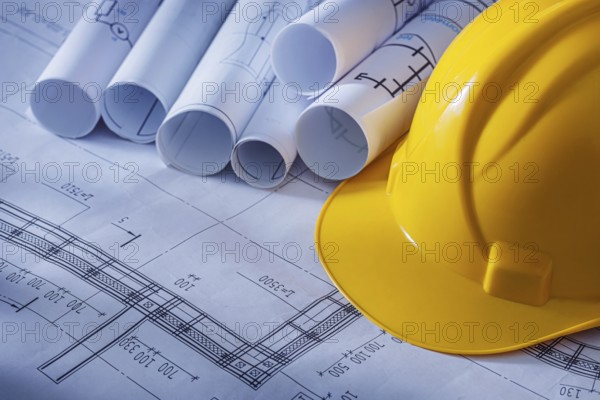 Rolled Blueprints And Construction Helmet