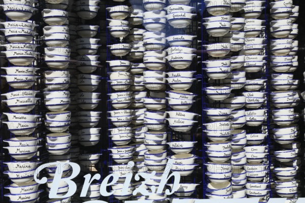 Pottery bowls with first names in the window of a souvenir shop, old town of Vannes, Breton Gwened,