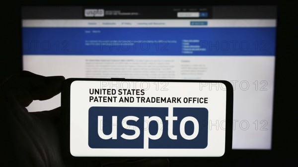 Stuttgart, Germany, 10-29-2023: Person holding smartphone with logo of agency United States Patent