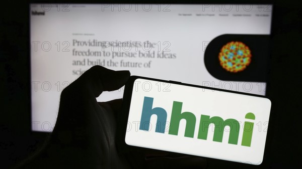 Stuttgart, Germany, 11-02-2023: Person holding cellphone with logo of American foundation Howard