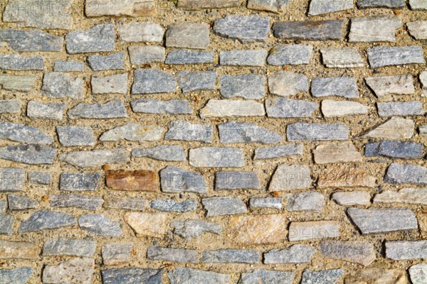 Stone pavement texture. Granite cobblestoned pavement background. Abstract background of old