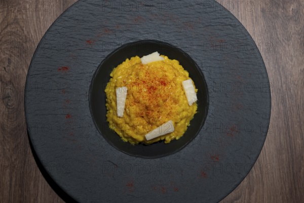 Elegant Plate with Risotto alla Milanese with Saffron and Parmesan Cheese in Lugano, Ticino,