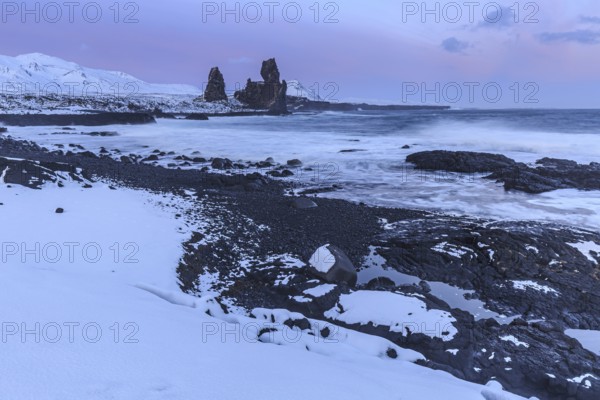 Rocks and surf on the coast, evening light, sun, snow, winter, Arnarstapi, Snaefellsnes,