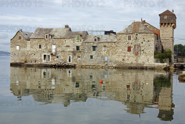 Old fortification from the Mediterranean reflected in the water, town of Kastela, Split, Dalmatia,