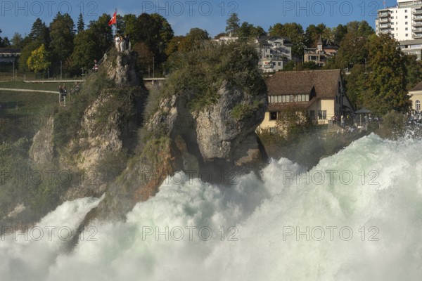 Rhine Falls seen from Laufen Castle, rocky island, Swiss flag, spray, Canton Zurich, on Neuhausen,