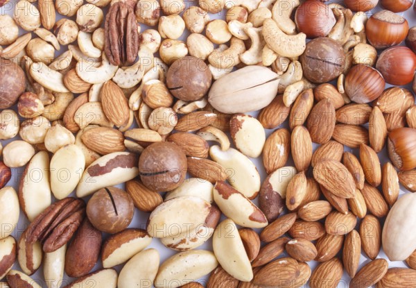 Background and texture made from different kinds of nuts. hazelnut, brazil nut, almond, pumpkin