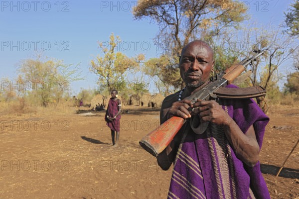 South Ethiopia, in the Maco National Park, in the village of the Mursi, Mursi man with rifle,