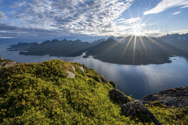 View of Fjord Raftsund and mountains in the evening light, sun star, view from the top of