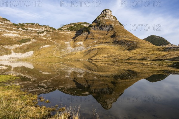 Lake Augstsee and the Atterkogel mountain on the Loser. Autumn, good weather, blue sky. Reflection.