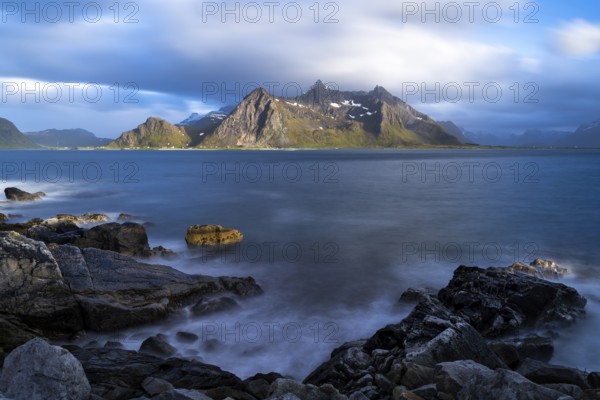 Landscape with sea and mountains on the Lofoten Islands, view across the fjord to the small town of