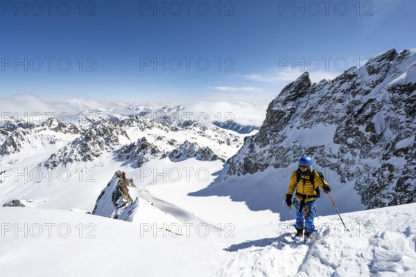 Mountaineer with ice axe and crampons, ascent through steep snowfield to Piz Kesch or Piz d'Es-cha