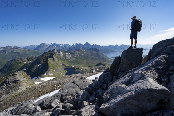 View of mountains and fjord landscape, mountain panorama, mountaineer at the summit of Rundfjellet,