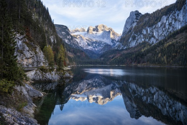 The Vordere Gosausee lake in autumn with a view of the Dachstein mountain range. The Gosaukamm on