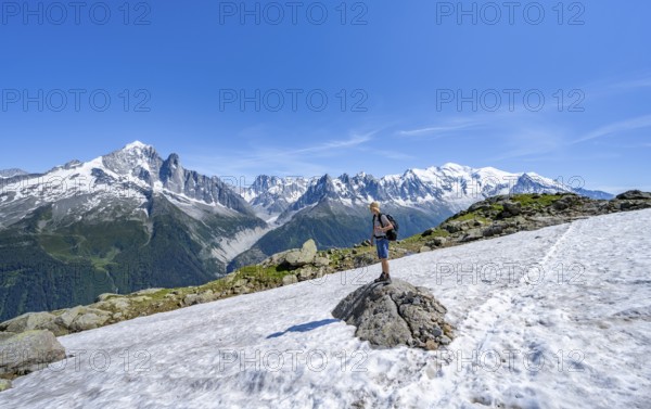 Mountaineer on a hiking trail in front of a mountain landscape, view of mountain peaks Aiguille