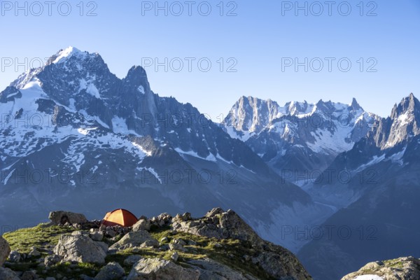 Red tent in front of a mountain panorama, mountain landscape in the morning light, mountain peaks