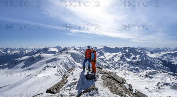 Couple, ski tourers at the summit of Monte Cevedale, mountain panorama, snow-covered mountain
