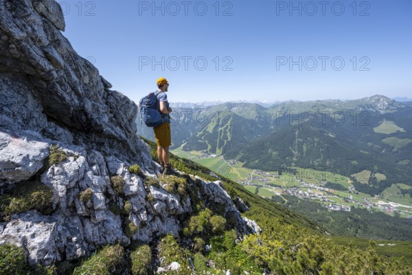 Mountaineer enjoying the view, ascent to Hochunnütz, Unnütz crossing, Brandenberg Alps, Tyrol,